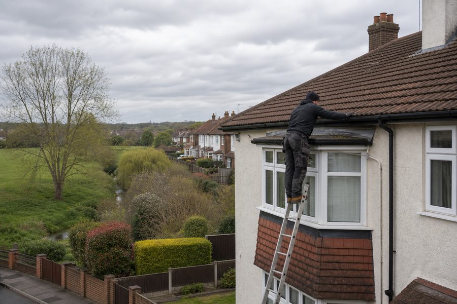 Roofer inspecting semis and extension roofs in Yeading